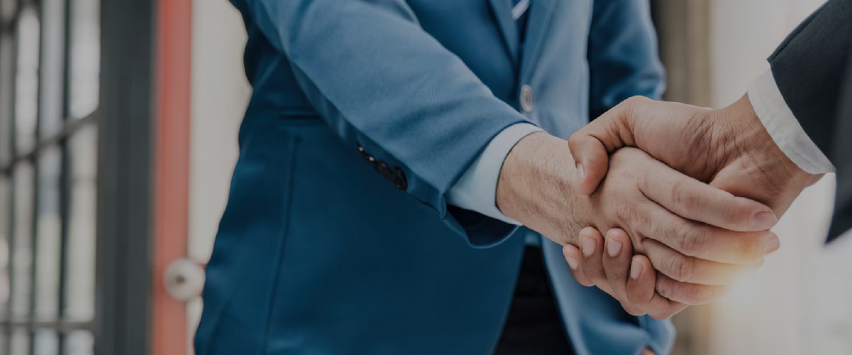 A MaintWiz Technology CMMS manager warmly welcoming a new employee with a handshake, symbolizing the beginning of a collaborative and supportive working relationship